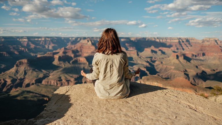 a person sitting on a rock